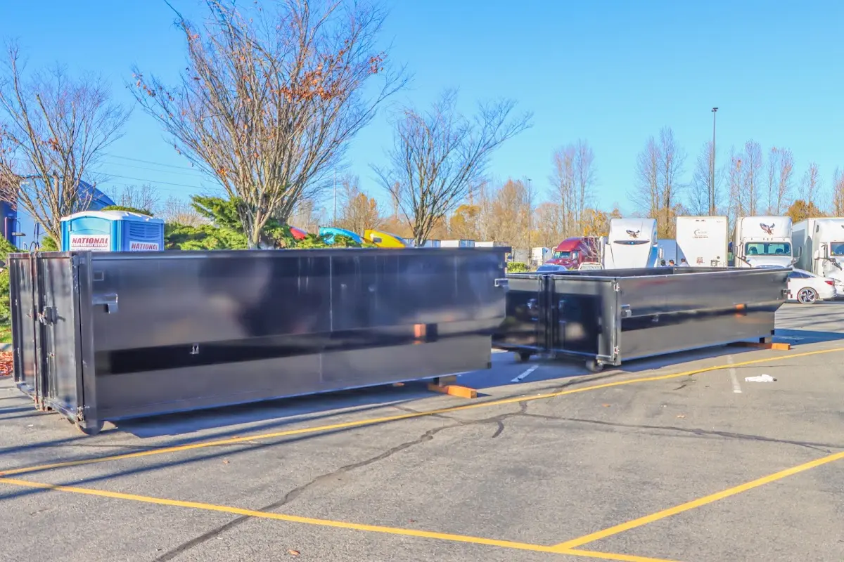 Professional dumpster rental service with roll-off container on residential driveway in Zebulon